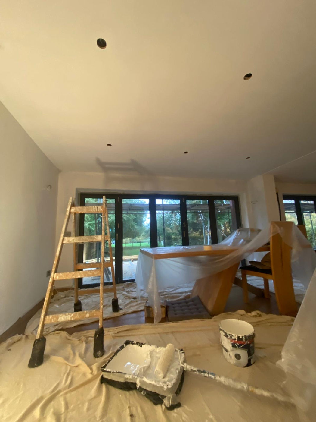 Interior room protected with coverings during painting and finishing work