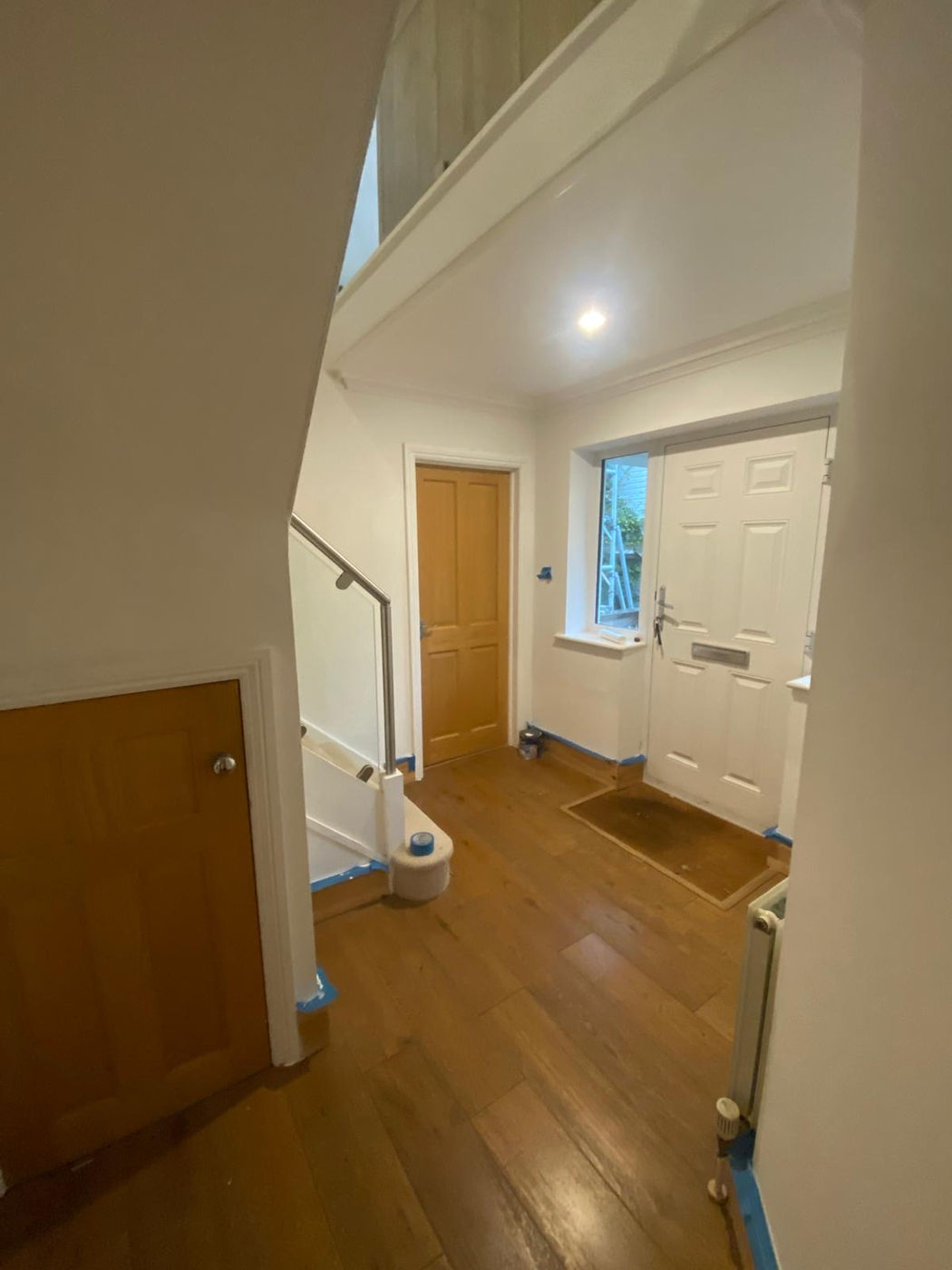 Hallway with wood flooring and finished entrance area