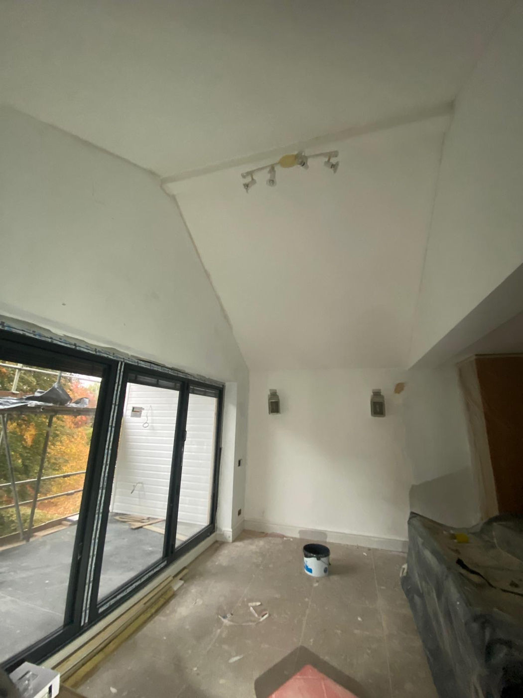 Stairwell wall and ceiling prepared for repair and decorating