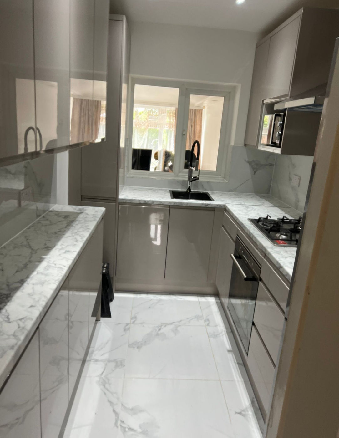 Kitchen finish with cabinets, worktops, tiled floor and sink area
