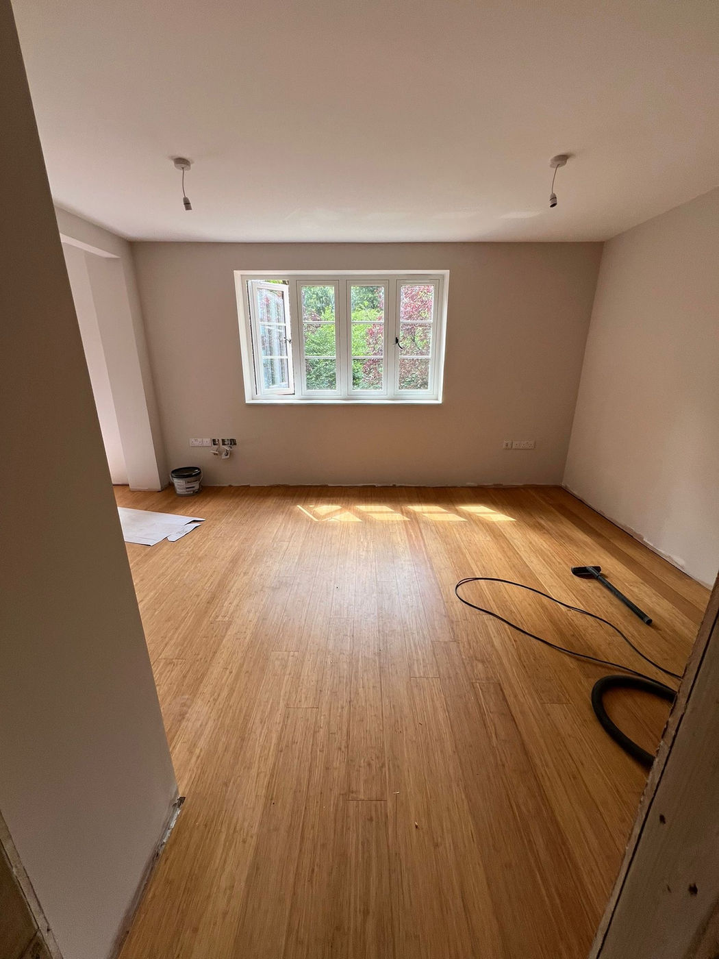 Empty room with floor preparation and wall repairs in progress