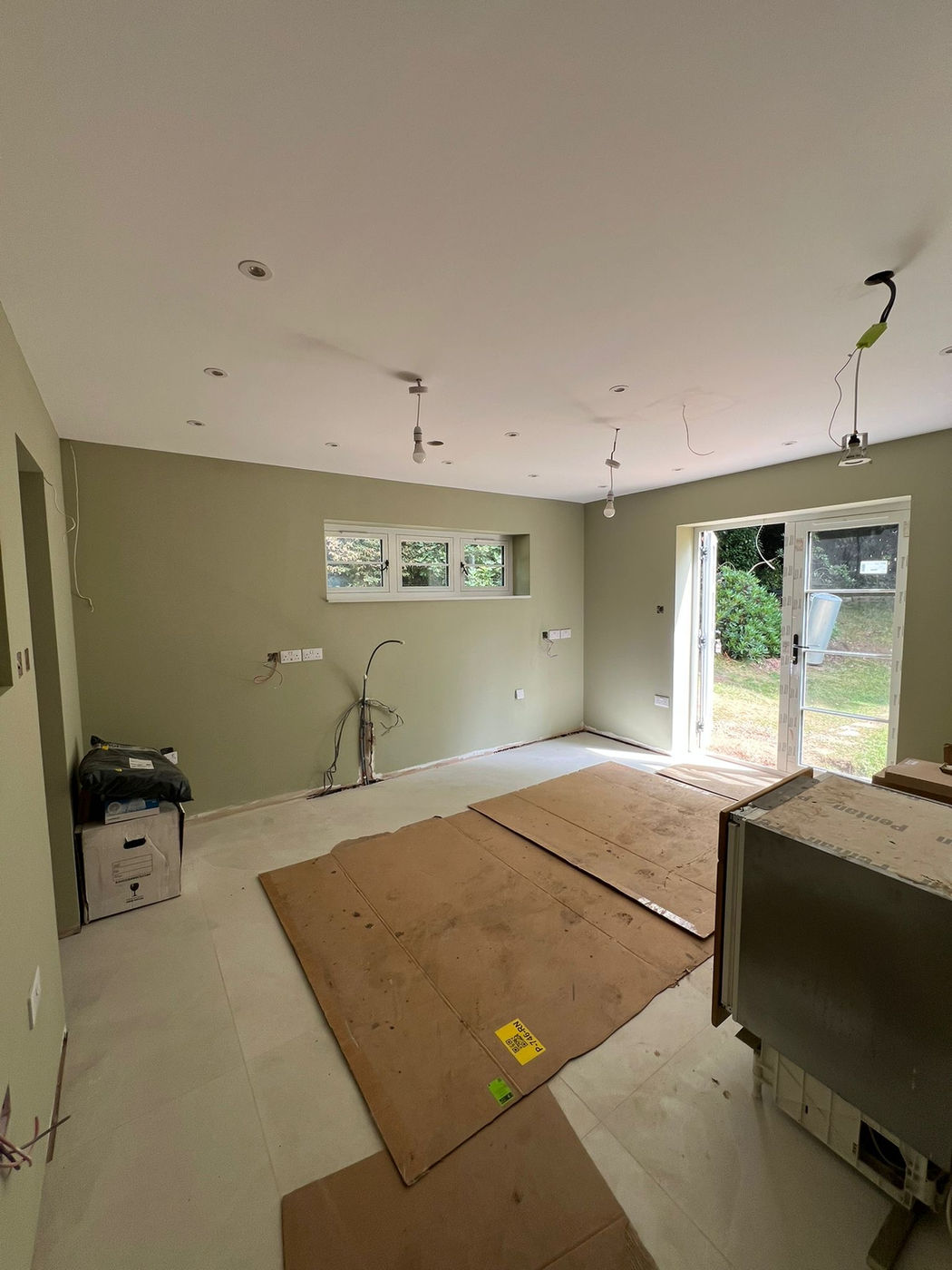 Open-plan kitchen and living room prepared for finishing and painting work