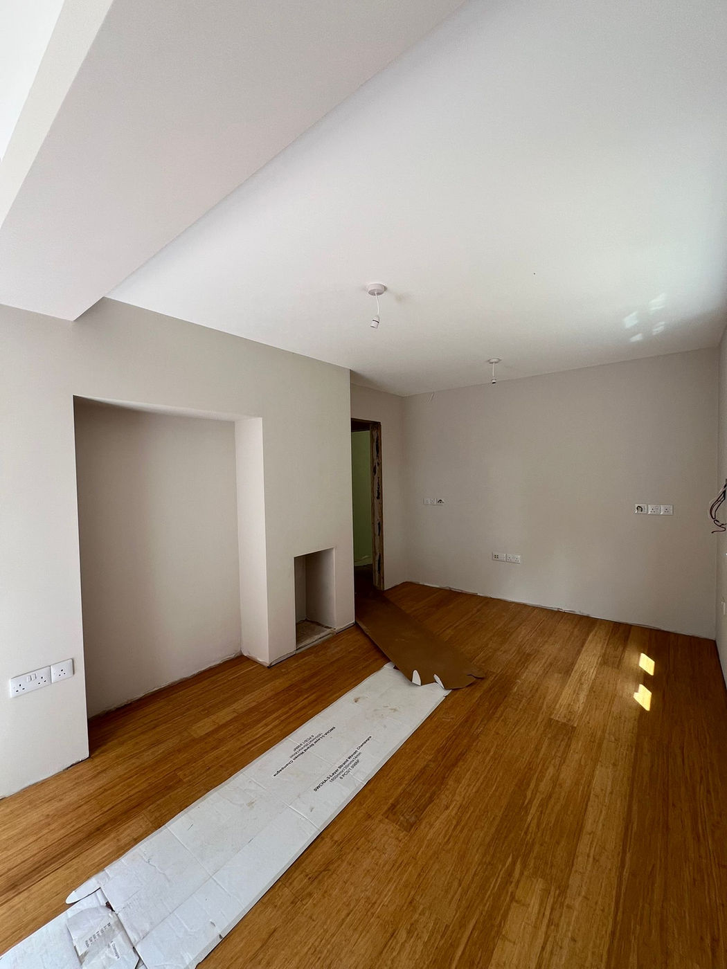 Room with flooring installed and walls prepared for finishing