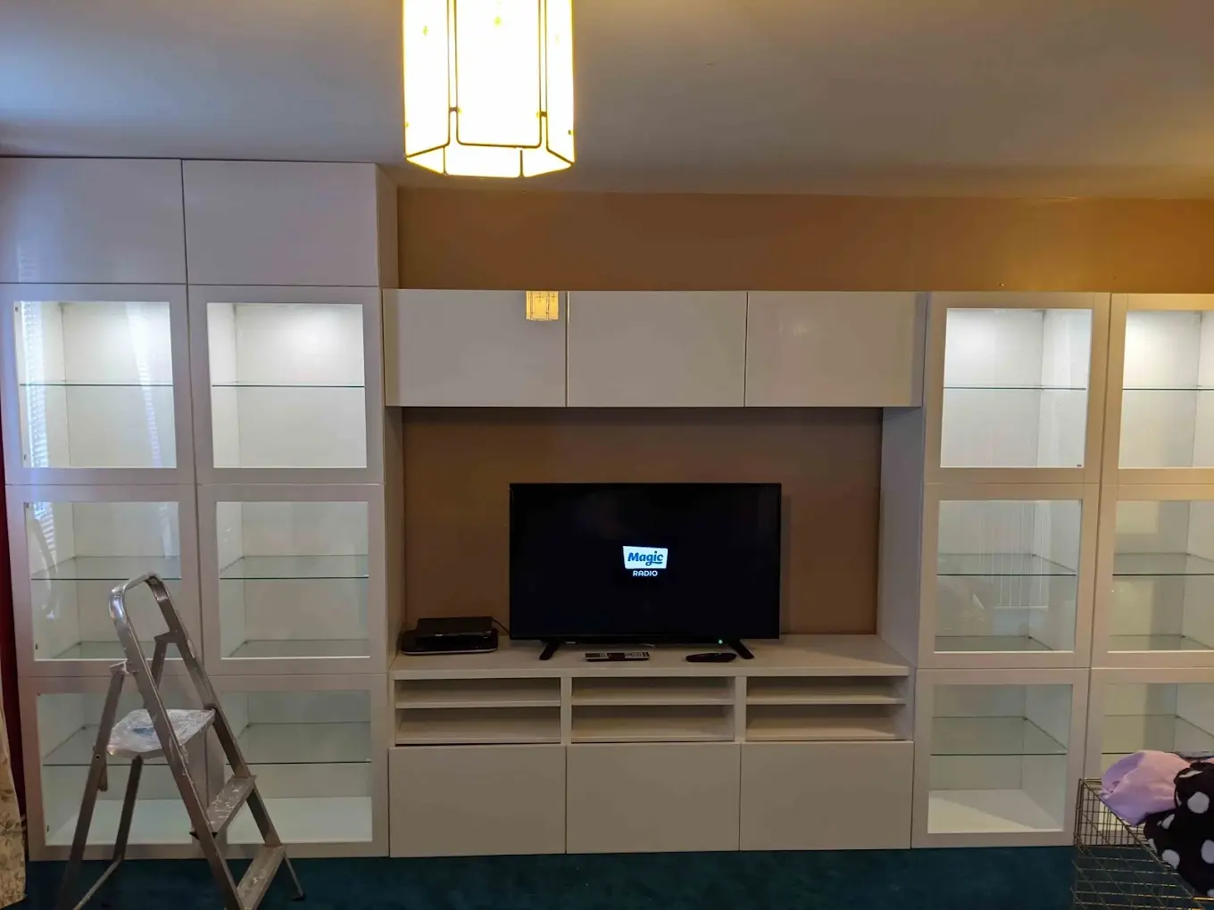 Fitted media wall and storage cabinets built around a television