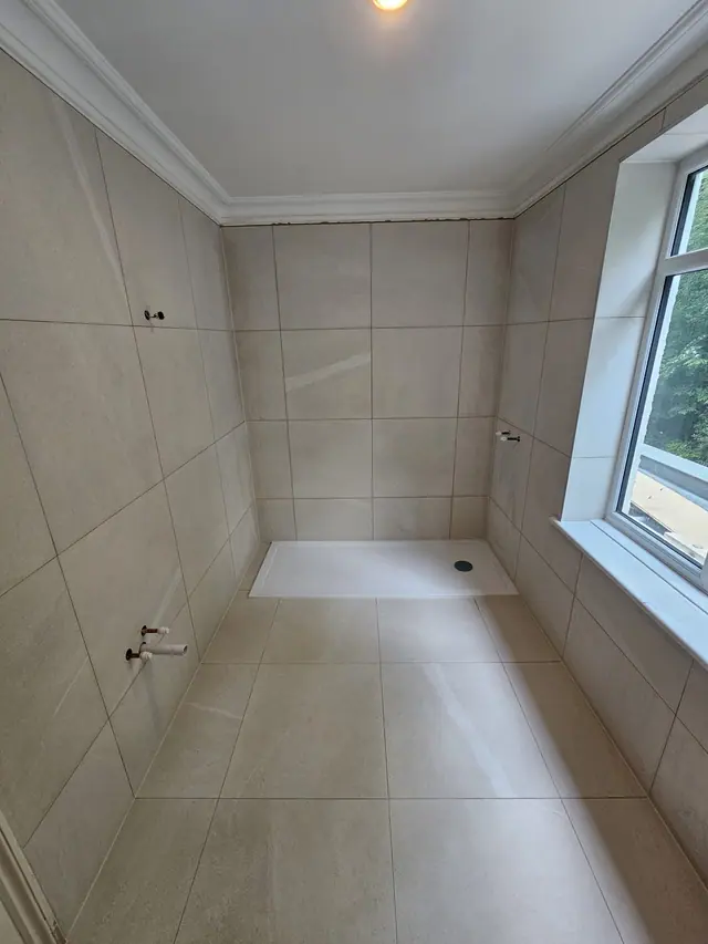 Bathroom shower wall and floor tiling with shower tray installed